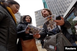Tour guide Ronnie Chatah, 36, gives the tour brochures to visitors in Beirut, Lebanon, Jan. 28, 2018.