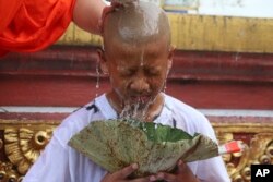 Chanin Vibulrungruang, his coach, and teammates who were rescued last week from a flooded cave have their heads shaved in a traditional Buddhist ceremony in Mae Sai district, Chiang Rai province, northern Thailand, Tuesday, July 24