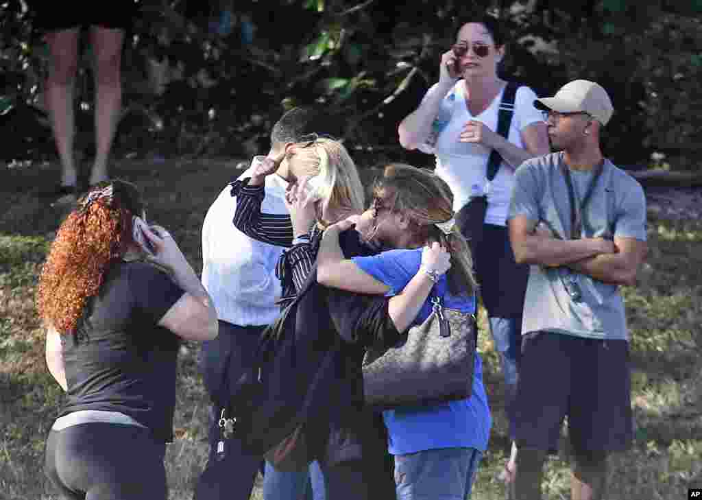 Anxious family members wait for news of students in Parkland, Florida, Feb. 14, 2018. A shooting at Marjory Stoneman Douglas High School sent students rushing into the streets as SWAT team members swarmed in and locked down the building.