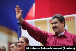 Venezuela's President Nicolas Maduro waves as he arrives for a rally with supporters in Caracas, Venezuela, Nov. 7, 2017.