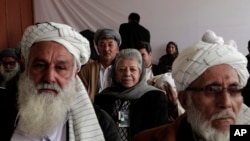 Afghan delegates listen to a speech from their committee chairman on the second day of the Loya Jirga, Kabul, Nov. 22, 2013.