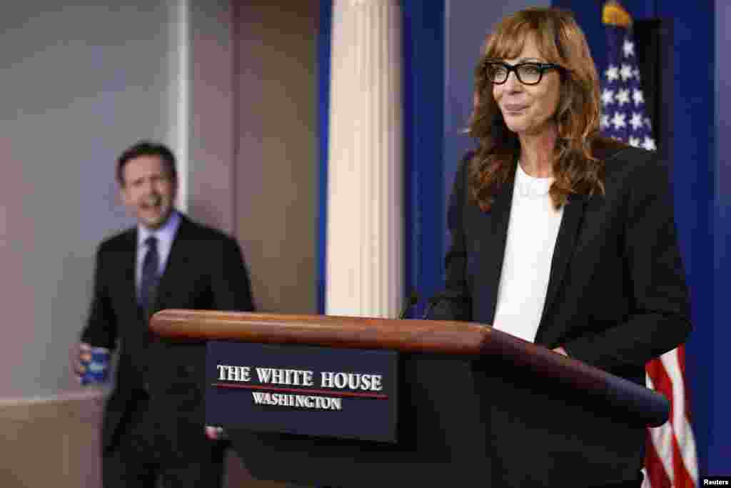 White House Press Secretary Josh Earnest (L) feigns shock that actress Allison Janney, who played a fictional press secretary in &quot;The West Wing&quot; television show, had commandeered the lectern before the daily press briefing at the White House in Washington, April 29, 2016.