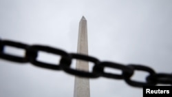 The obelisk of the Washington Monument is seen behind a chain, as the partial government shutdown becomes the longest in U.S. history, in Washington, Jan. 13, 2019.