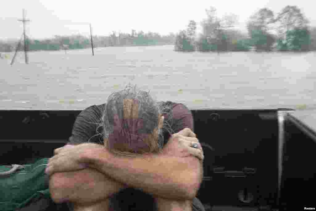 A resident of Plaquemines Parish who was rescued from his flooded home sits in the back of a pickup truck during Hurricane Isaac in Braithwaite, Louisiana August 29, 2012. 