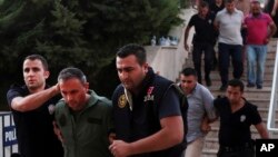 Members of Turkey armed forces are escorted by police for their suspected involvement in Friday's attempted coup at the court house in Mugla, Turkey, July 17, 2016.