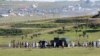 The casket of former South African president Nelson Mandela is carried on a gun carriage toward the dome for his funeral service in Qunu, Dec. 15, 2013. 