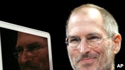 FILE - In this Jan. 15, 2008, file photo, Apple CEO Steve Jobs holds up the new MacBook Air after giving the keynote address at the Apple MacWorld Conference in San Francisco. Apple on Wednesday, Oct. 5, 2011 said Jobs has died. He was 56. (AP Photo/Jeff 