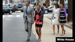 President Barack Obama and First Lady Michelle Obama walk with their daughters Sasha and Malia (R) to attend Easter service at St. John's Church in Washington, D.C., March 31, 2013. (Official White House Photo by Pete Souza)