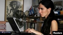Yoani Sanchez works on her laptop at her home in Havana, February 9, 2011.