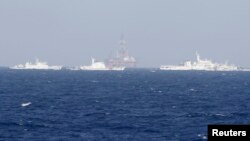 FILE - Chinese oil rig Haiyang Shi You 981 is seen surrounded by ships of China Coast Guard in the South China Sea, about 210 km (130 miles) off shore of Vietnam.