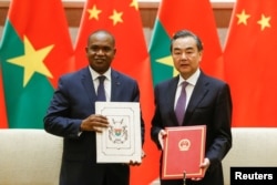 China's Foreign Minister Wang Yi and Burkina Faso Foreign Minister Alpha Barry attend a signing ceremony establishing diplomatic relations between the two countries in Beijing, China, May 26, 2018.