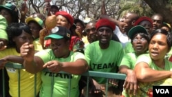 Zanu-PF supporters outside parliament during the official opening ceremony Tuesday