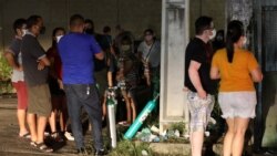 Relatives of COVID-19 patients gather to buy oxygen and fill cylinders at a private company in Manaus, on January 15, 2021.