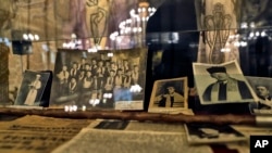 Old pictures showing the daily life of the Romanian Jewish community are on display at the main synagogue in Bucharest, Romania, Jan. 27, 2017, during a commemoration service for those killed 75 years ago.