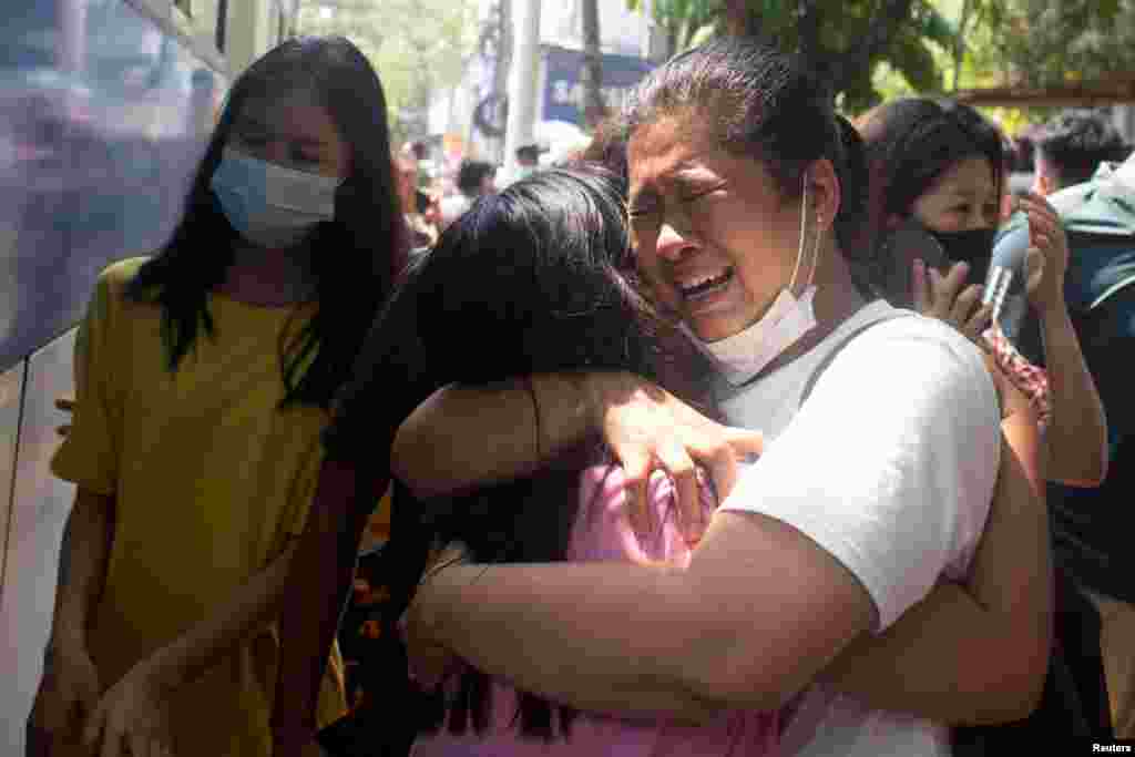 Protesters detained by police during the anti-coup demonstrations react after being released at Tamwe township police station in Yangon, Myanmar.