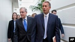 House Speaker John Boehner of Ohio, right, walks with Senate Minority Leader Mitch McConnell of Ky., left, as they make their way to a GOP strategy session on Capitol Hill in Washington, Nov. 19, 2013.