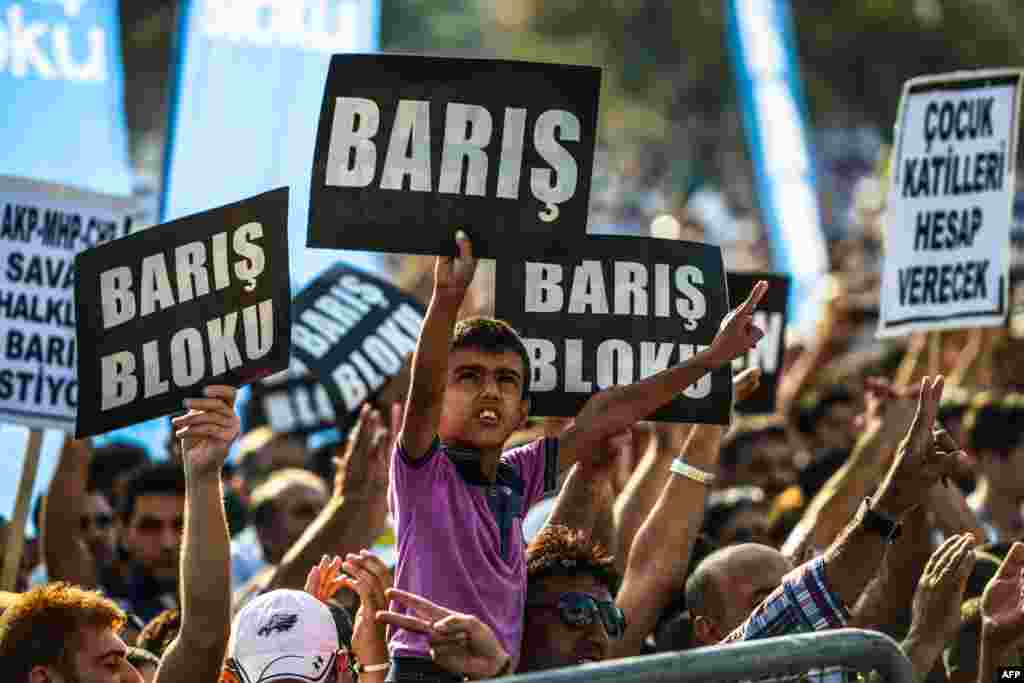 People hold placards reading &quot;Peace&quot; and &quot;Peace Bloc&quot; gather for a meeting organized by the Peace Bloc to call for peace, in Istanbul, Turkey.