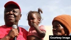 Morgan Tsvangirai captured at a village in Zimbabwe visiting some citizens.