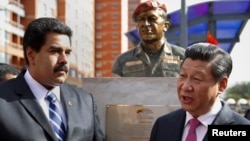 China's President Xi Jinping (R) speaks with Venezuela's President Nicolas Maduro. Venezuela has looked to China for assistance as its economy weakens, partly as a result of low oil prices. ( REUTERS/Carlos Garcia Rawlins )