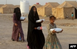 Displaced Iraqis from Fallujah are seen at a camp in Amiriyiah al-Fallujah, some 30 kms south of from the embattled city, June 20, 2016.