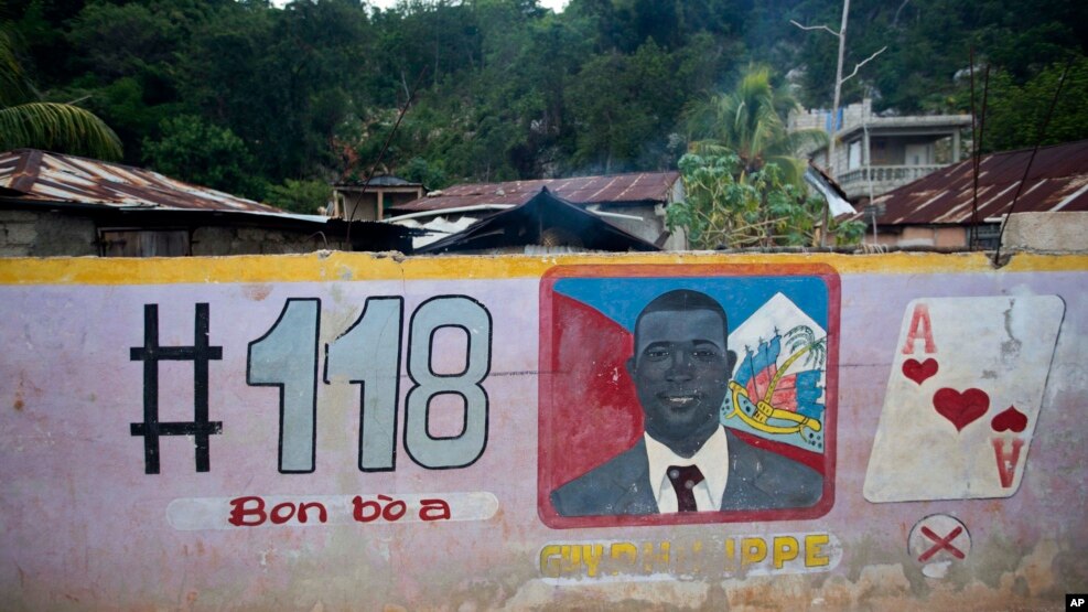 FILE - A mural features senatorial candidate Guy Philippe in Pestel, Haiti, Aug. 25, 2016.