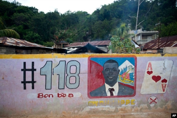 FILE - A mural feature senatorial candidate Guy Philippe in Pestel, Haiti, Aug. 25, 2016.