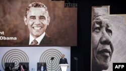 Former U.S. President Barack Obama, right, speaks during the 2018 Nelson Mandela Annual Lecture at the Wanderers cricket stadium in Johannesburg, July 17, 2018.