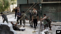 Members of the Free Syrian Army use a catapult to launch a homemade bomb during clashes with pro-government soldiers in the city of Aleppo, October 15, 2012. 