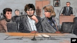 FILE - In this courtroom sketch, Dzhokhar Tsarnaev, center, is depicted between defense attorneys Miriam Conrad, left, and Judy Clarke, right, during his federal death penalty trial.