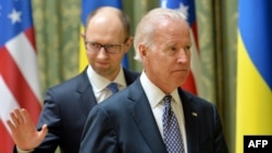 US Vice President Joe Biden (R) and Ukraine's acting Prime Minister Arseniy Yatsenyuk leave after a joint press conference in Kyiv on April 22, 2014. 
