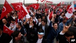 Supporters of Devlet Bahceli, the leader of the Nationalist Movement Party (MHP), chant slogans as he addresses a rally ahead of the Nov. 1 general elections, in Istanbul, Oct. 18, 2015.