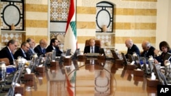 In this photo released by Lebanon's official government photographer Dalati Nohra, shows Lebanese President Michel Aoun, center, heading a cabinet meeting, at the presidential palace, in Baabda east of Beirut, Lebanon, Tuesday, April 30, 2019. 