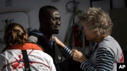 A migrant reacts as he is greeted by MSF workers aboard the MV Aquarius, as 193 people and two corpses are recovered, Jan. 13, 2017, from international waters in the Mediterranean Sea about 22 miles (35 Km) north of Sabrata, Libya. 