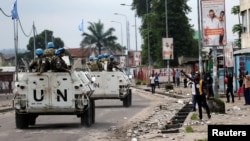 Peacekeepers serving in the United Nations Organization Stabilization Mission in the Democratic Republic of the Congo (MONUSCO) patrol in their armored personnel carrier during demonstrations against Congolese President Joseph Kabila in the streets of the