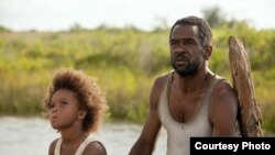 Quvenzhane Wallis as "Hushpuppy" and Dwight Henry as "Wink" on the set of Beasts of The Southern Wild (Photo: Fox Searchlight / Mary Cybulski)