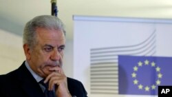 EU Migration Commissioner Dimitris Avramopoulos, shown at a news conference after a meeting with local officials in Athens on June 12, 2015, says that "now is the moment for actions" on migrant redistribution. "We should not waste any more time."