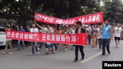 Local residents march during a protest along a street in Shifang, Sichuan province July 3, 2012.