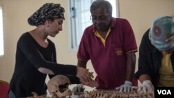 Valeska Martinez, left, and her colleagues analyze human remains — which appear to have suffered a gunshot wound to the head — in a lab in Berbera, Somaliland. (J. Patinkin/VOA)