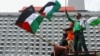 Sejumlah anggota organisasi buruh Indonesia memegang bendera Palestina saat melakukan aksi protes terhadap Israel di luar gedung PBB di Jakarta, 18 Mei 2021. (Foto: REUTERS/Ajeng Dinar Ulfiana)