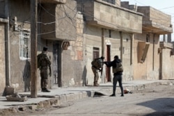 Kurdish security forces deploy in Syria's northern city of Hasakeh, Jan. 22, 2022, amid ongoing fighting for a third day with the Islamic State group.
