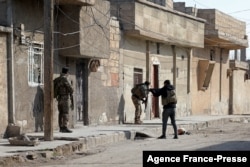 Kurdish security forces deploy in Syria's northern city of Hasakah, Jan. 22, 2022, during fighting with the Islamic State group.