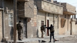 Kurdish security forces deploy in Syria's northern city of Hasakeh, Jan. 22, 2022, amid ongoing fighting for a third day with the Islamic State group.