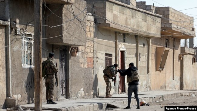 Kurdish security forces deploy in Syria's northern city of Hasakeh, Jan. 22, 2022, amid ongoing fighting for a third day with the Islamic State group.