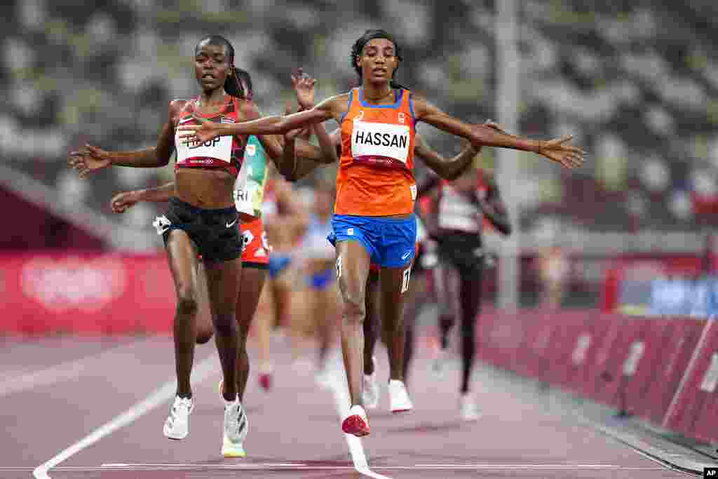 Sifan Hassan, of the Netherlands, right, crosses the finish line ahead of Agnes Jebet Tirop, of Kenya, left, to win a heat in the women&#39;s 5,000-meter run at the 2020 Summer Olympics, Friday, July 30, 2021, in Tokyo. (AP Photo/Petr David Josek)
