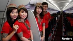 VietJet cabin crew members are seen inside a A320 airplane before departure for Bangkok, at Noi Bai international airport in Hanoi.