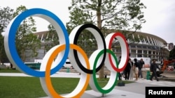 Olympic rings are displayed in front of the construction site of the New National Stadium, the main stadium of Tokyo 2020 Olympics and Paralympics, during a media opportunity in Tokyo, Japan July 3, 2019. (REUTERS/Issei Kato) 