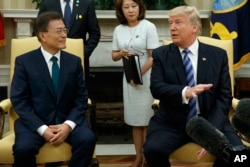 FILE - President Donald Trump meets with South Korean President Moon Jae-in in the Oval Office of the White House in Washington, June 30, 2017.