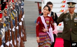 FILE - Myanmar leader Aung San Suu Kyi arrives at Clark International Airport, north of Manila, Philippines to attend the 31st ASEAN Summit and Related Summits in Manila, Nov. 11, 2017.
