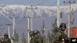 An Afghan National Army soldiers keeps watch after an attack at Camp Phoenix in Kabul April 2, 2011