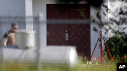 FILE - Bullet holes were marked by police at the front of the building as law enforcement officials continue to investigate the scene of a shooting at the First Baptist Church of Sutherland Springs in Sutherland Springs, Texas, Nov. 7, 2017.